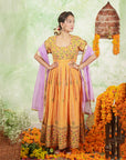 A women wearing Orange Anarkali Kurta Set with Purple Dupatta.