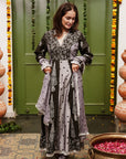 A women wearing black and grey Chanderi silk Anarkali kurta set with heavy dupatta.