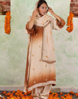 A women wearing beige and brown colored Kurta Set with Dupatta.