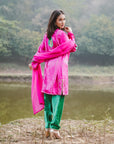 A women wearing pink and green colored Kurta Set with Dupatta.