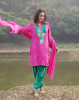 A women wearing pink and green colored Kurta Set with Dupatta.