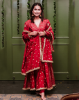 A women wearing Red Anarkali Suit with Heavy Dupatta.