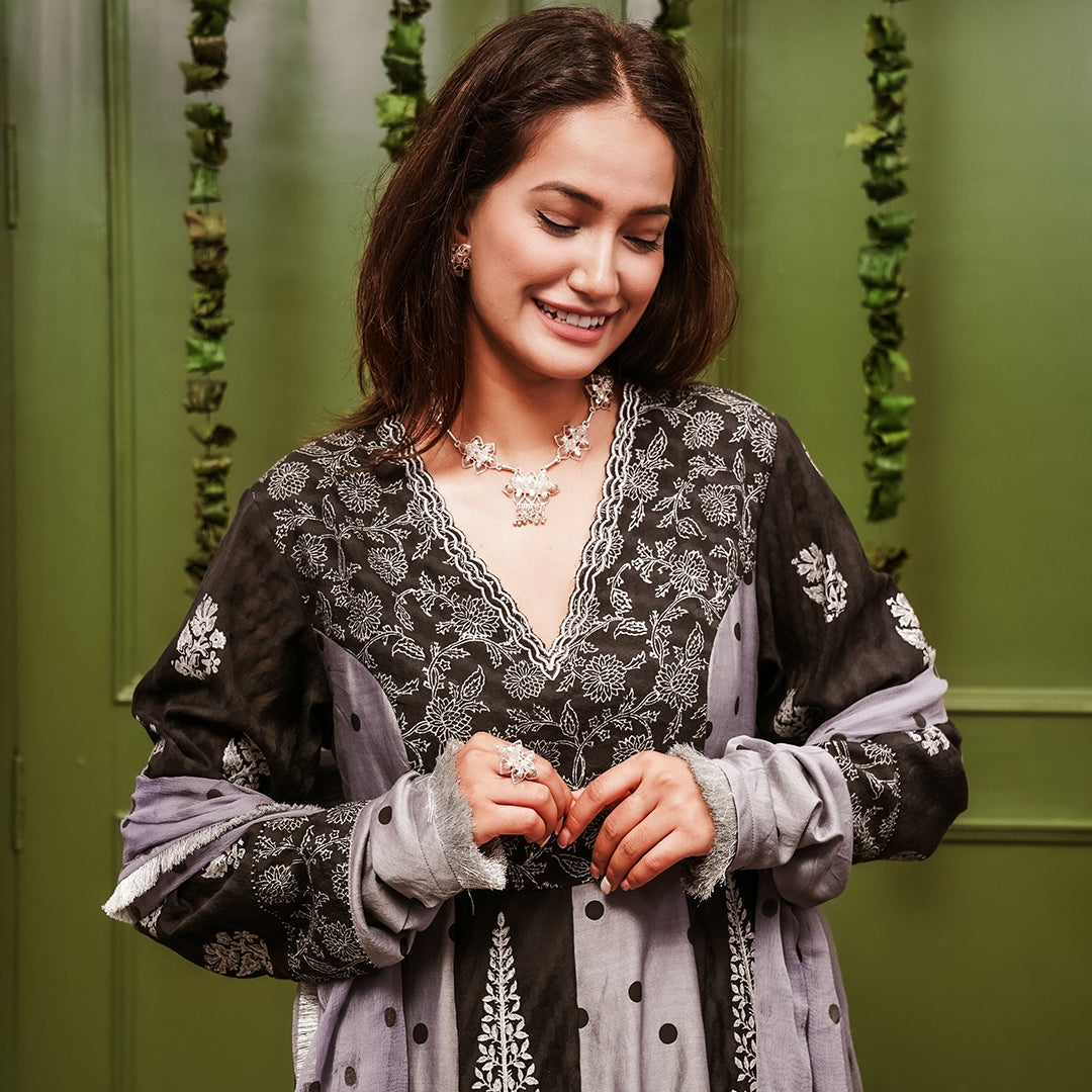 A women wearing black and grey Chanderi silk Anarkali kurta set.