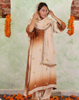 A women wearing beige and brown colored Kurta Set with Dupatta.