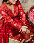 A women wearing Red Anarkali Suit with Heavy Dupatta.