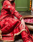 A women wearing Red Anarkali Suit with Heavy Dupatta.
