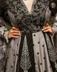 A women wearing black and grey Chanderi silk Anarkali kurta set.