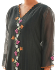 A women wearing black colored kurta set.