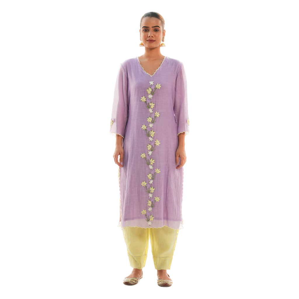 A women wearing purple colored kurta set with lemon colored pants.