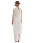 A women wearing designer white kurta set.