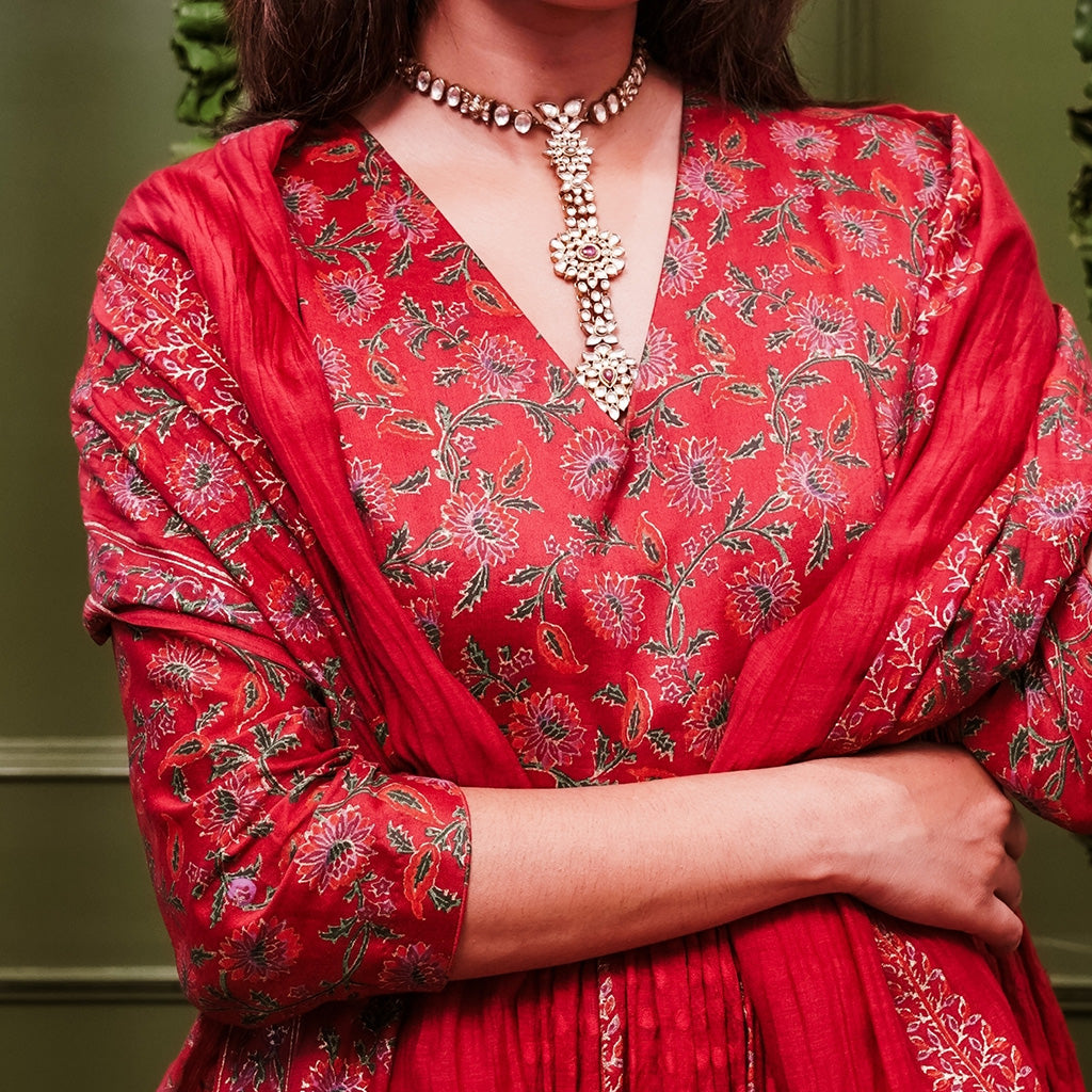 A women wearing Red Anarkali Suit Set with Dupatta.