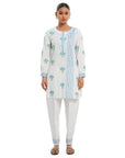 A women wearing White Kurta Set with blue colored floral print on it.