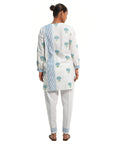 A women wearing White Kurta Set with blue colored floral print on it.