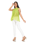 A women wearing parrot green colored designer sleeveless top with white pants.