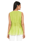 A women wearing parrot green colored designer sleeveless top with white pants.
