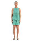 A women wearing aqua colored sleeveless top with aqua colored shorts