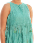 A women wearing aqua colored sleeveless top with aqua colored shorts