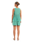 A women wearing aqua colored sleeveless top with aqua colored shorts