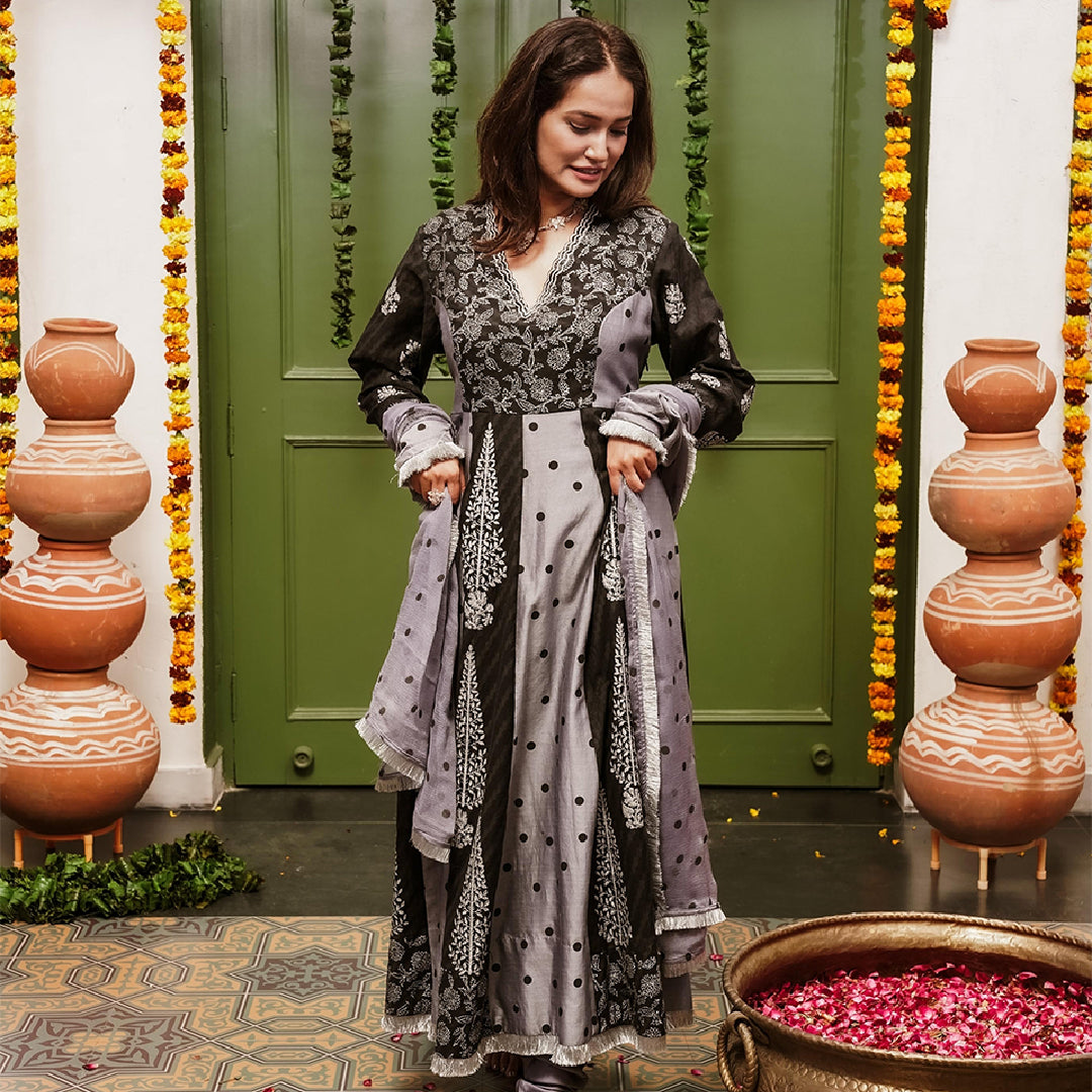 A women wearing black and grey Chanderi silk Anarkali kurta set with heavy dupatta.