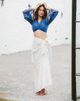 A woman wearing Blue Colored Blouse and White Drape Skirt Co-ord Set.