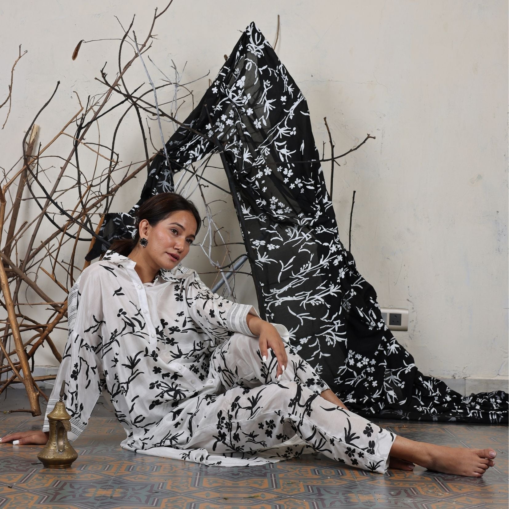 A woman sitting on the floor wearing Black and White Silk Co-Ord Set.