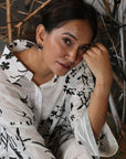 A woman sitting on the floor wearing Black and White Silk Co-Ord Set.