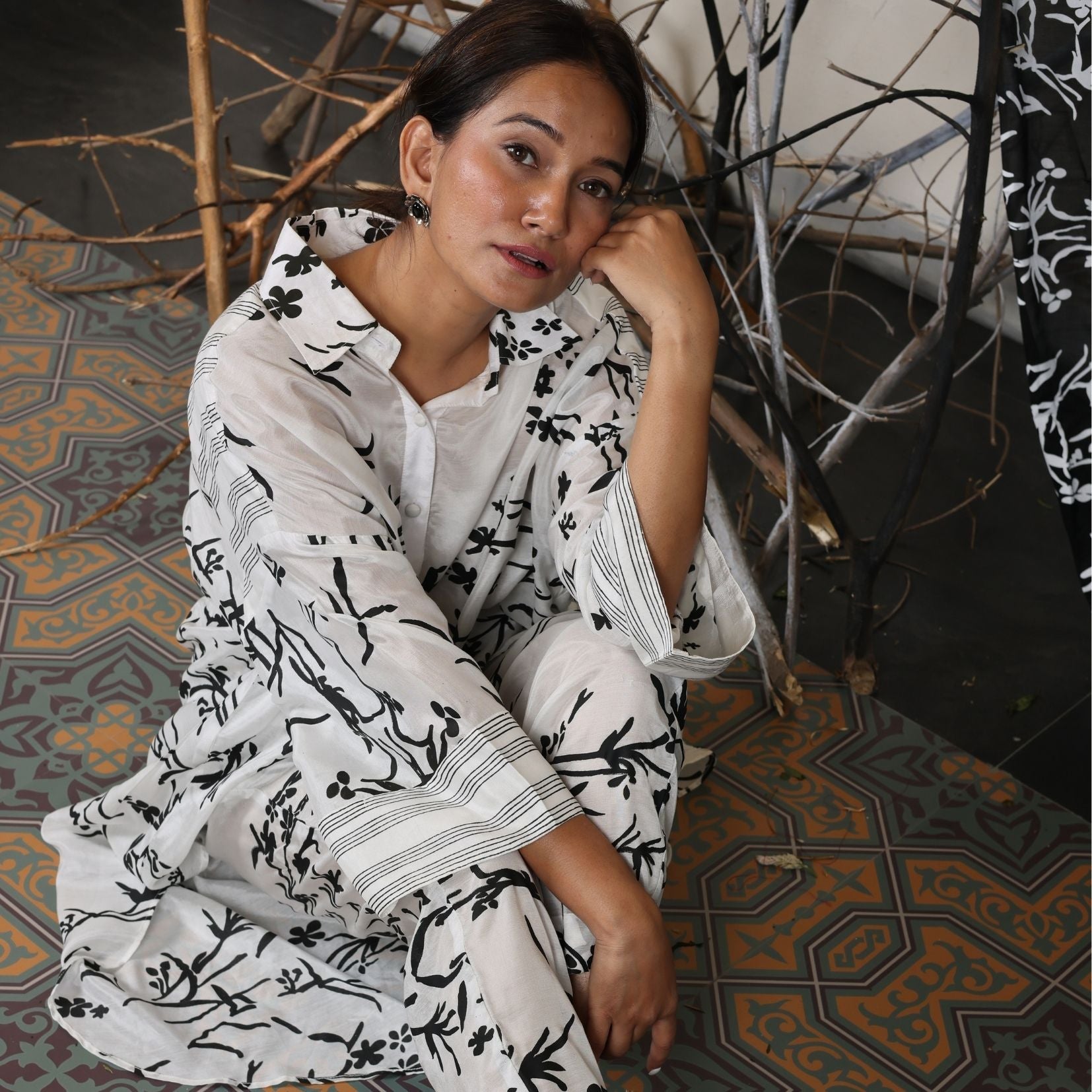 A woman sitting on the floor wearing Black and White Silk Co-Ord Set.