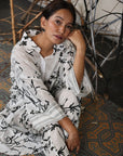 A woman sitting on the floor wearing Black and White Silk Co-Ord Set.