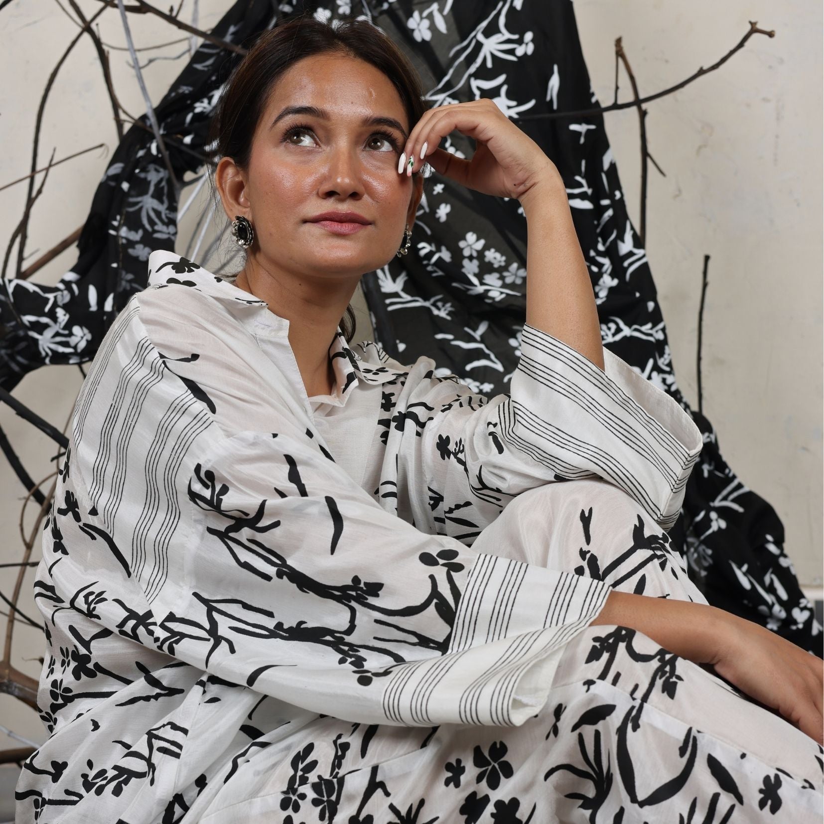 A woman sitting on the floor wearing Black and White Silk Co-Ord Set.