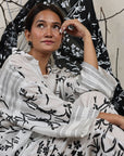 A woman sitting on the floor wearing Black and White Silk Co-Ord Set.