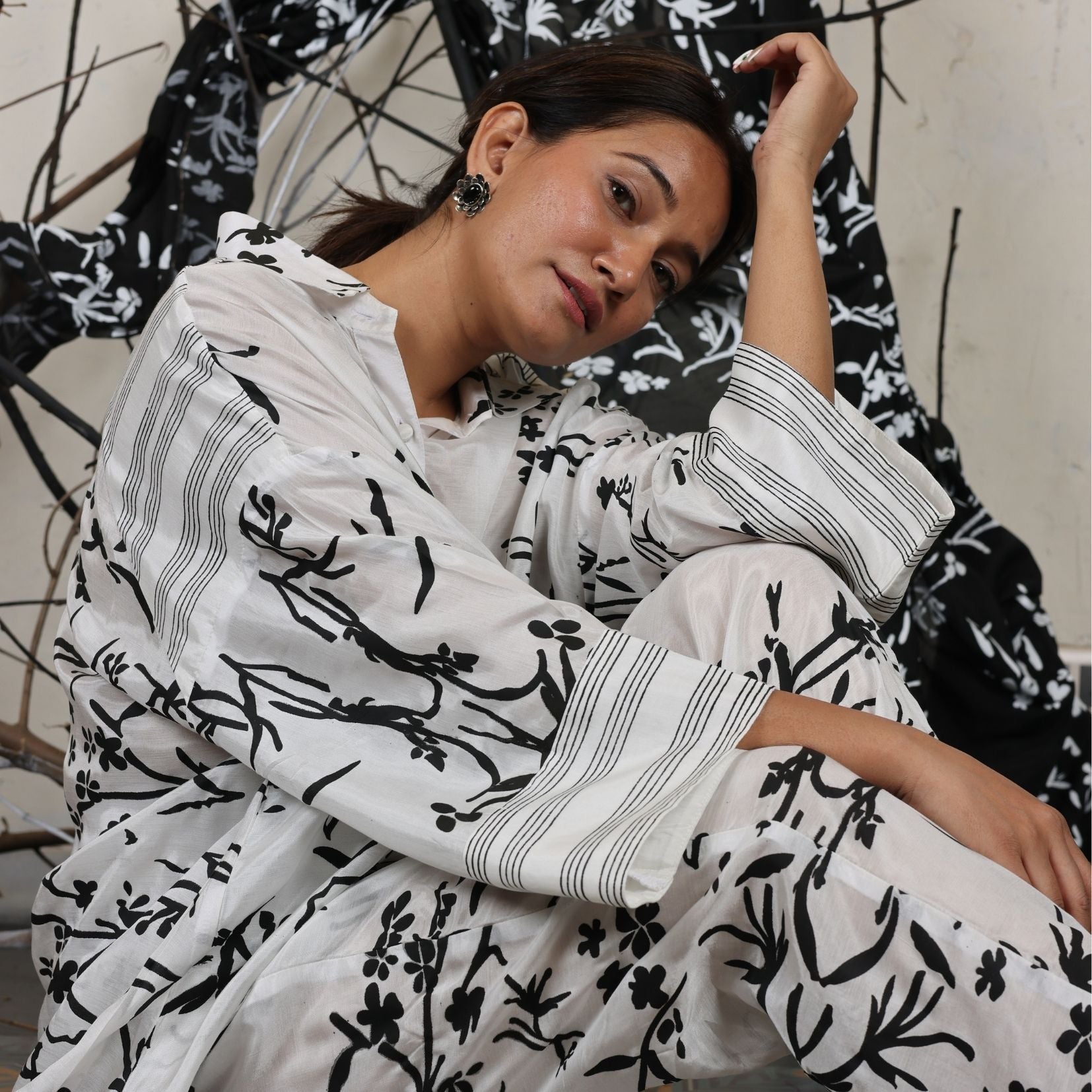 A woman sitting on the floor wearing Black and White Silk Co-Ord Set.