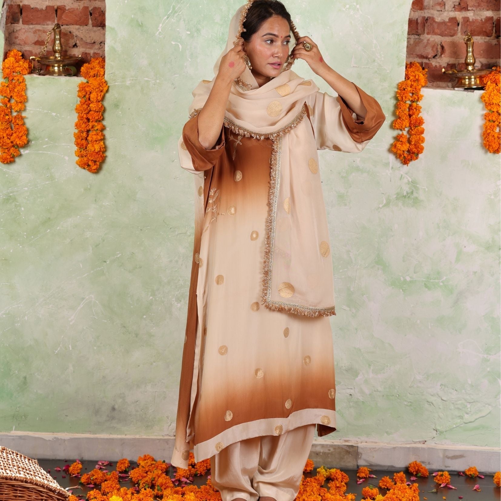 A women wearing beige and brown colored Kurta Set with Dupatta.