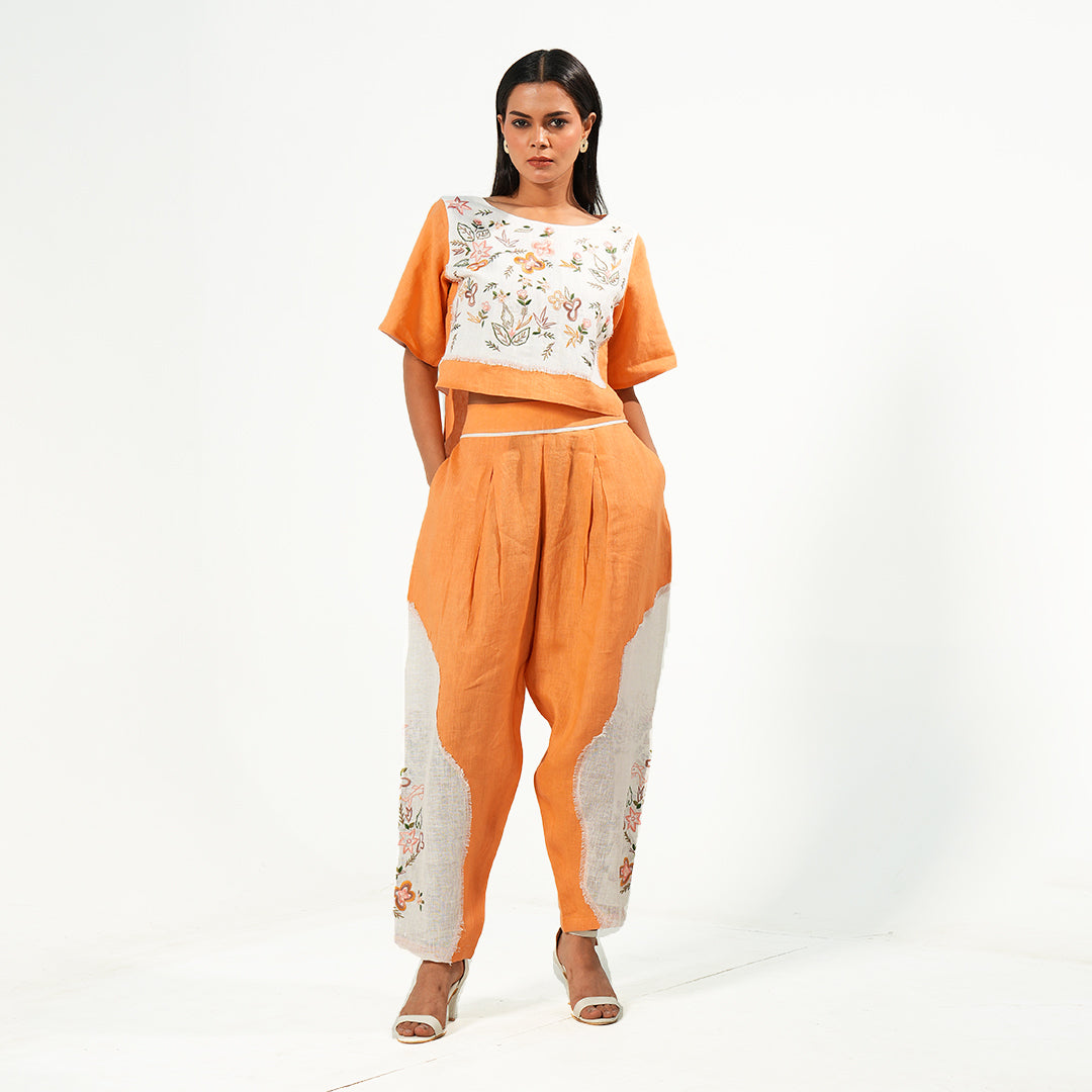 A woman wearing orange and white colored oversized co-ord set.