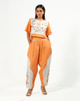 A woman wearing orange and white colored oversized co-ord set.