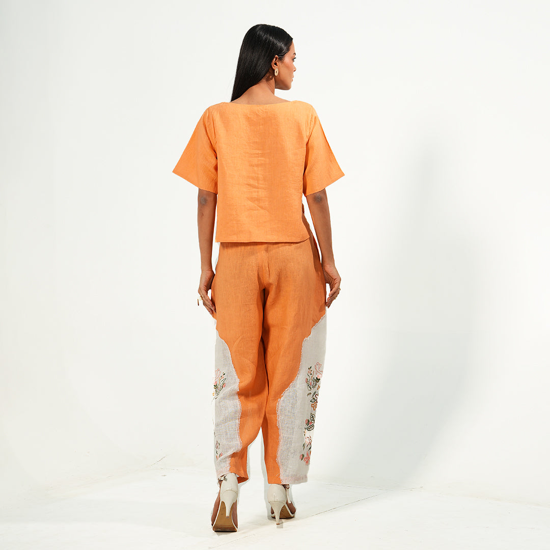 A woman wearing orange and white colored oversized co-ord set.