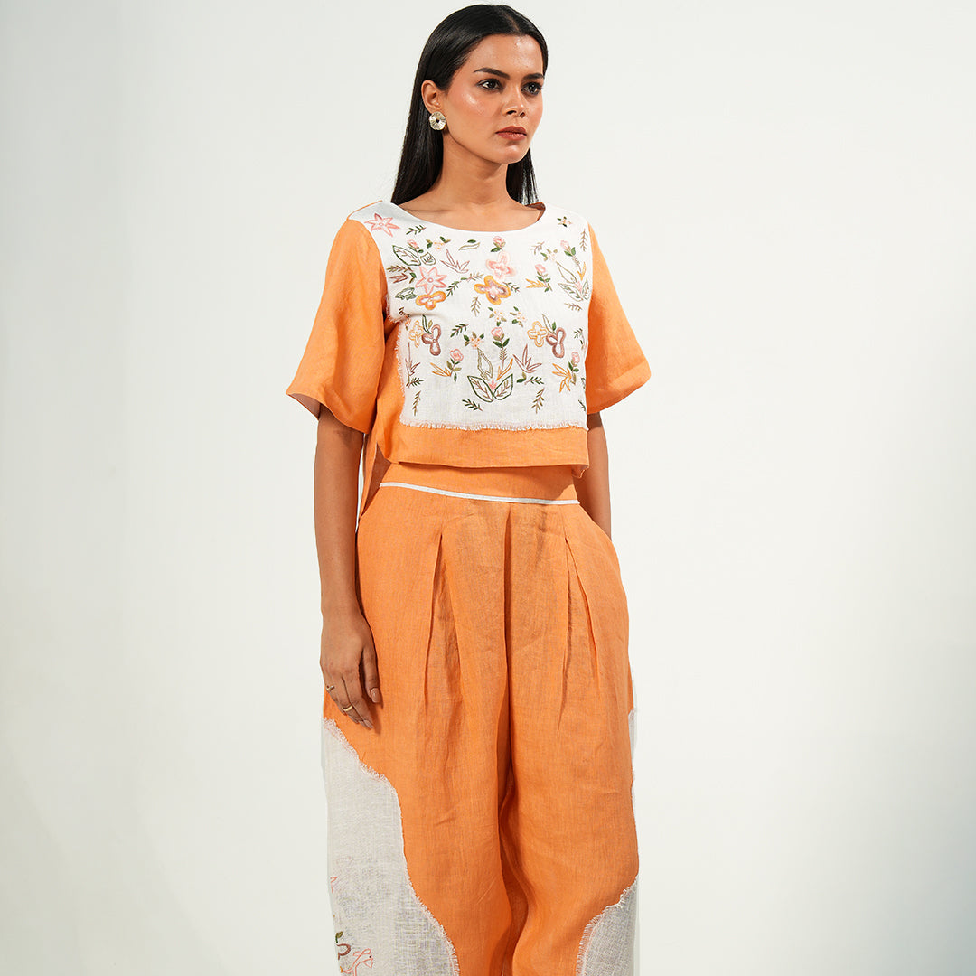 A woman wearing orange and white colored oversized co-ord set.