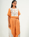 A woman wearing orange and white colored oversized co-ord set.