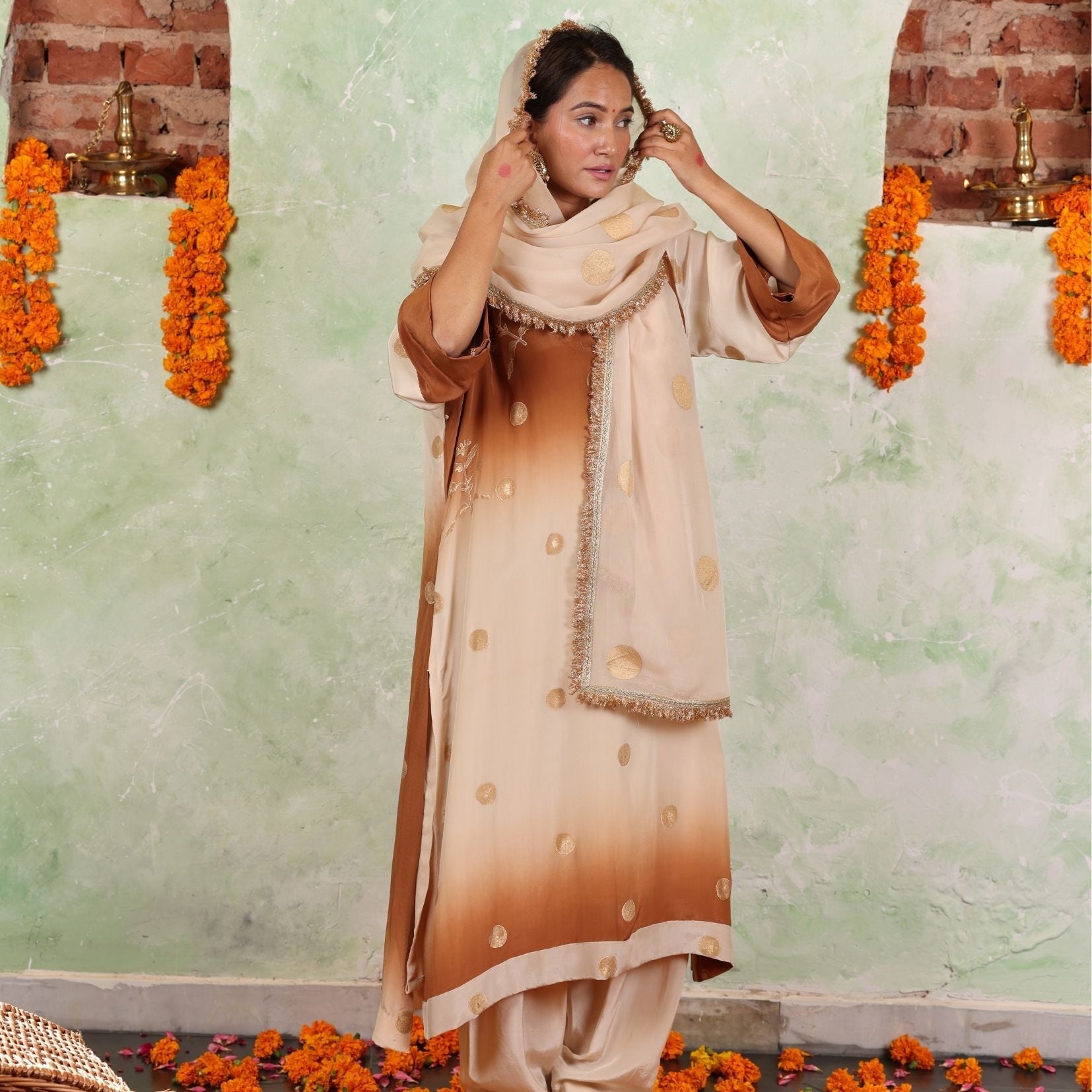 A women wearing beige and brown colored Kurta Set with Dupatta.