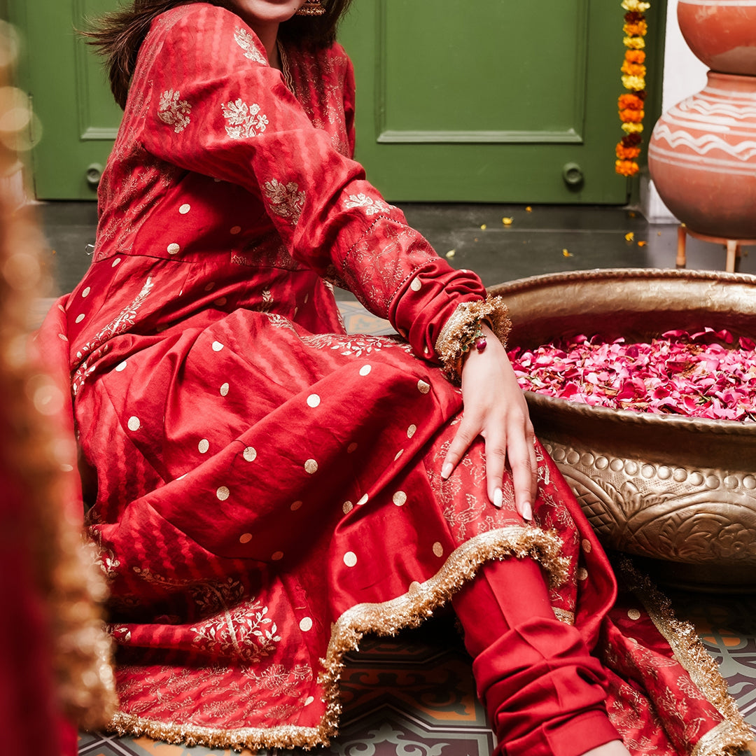 A women wearing Red Anarkali Suit with Heavy Dupatta.