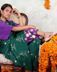 A women sitting on a chair wearing Kaftan Kurta Set of green and purple colour.