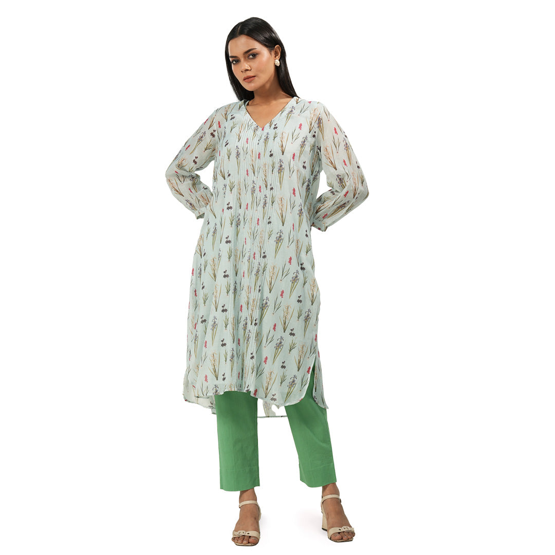 A woman wearing Green and White Colored Kurta Set with Pants.