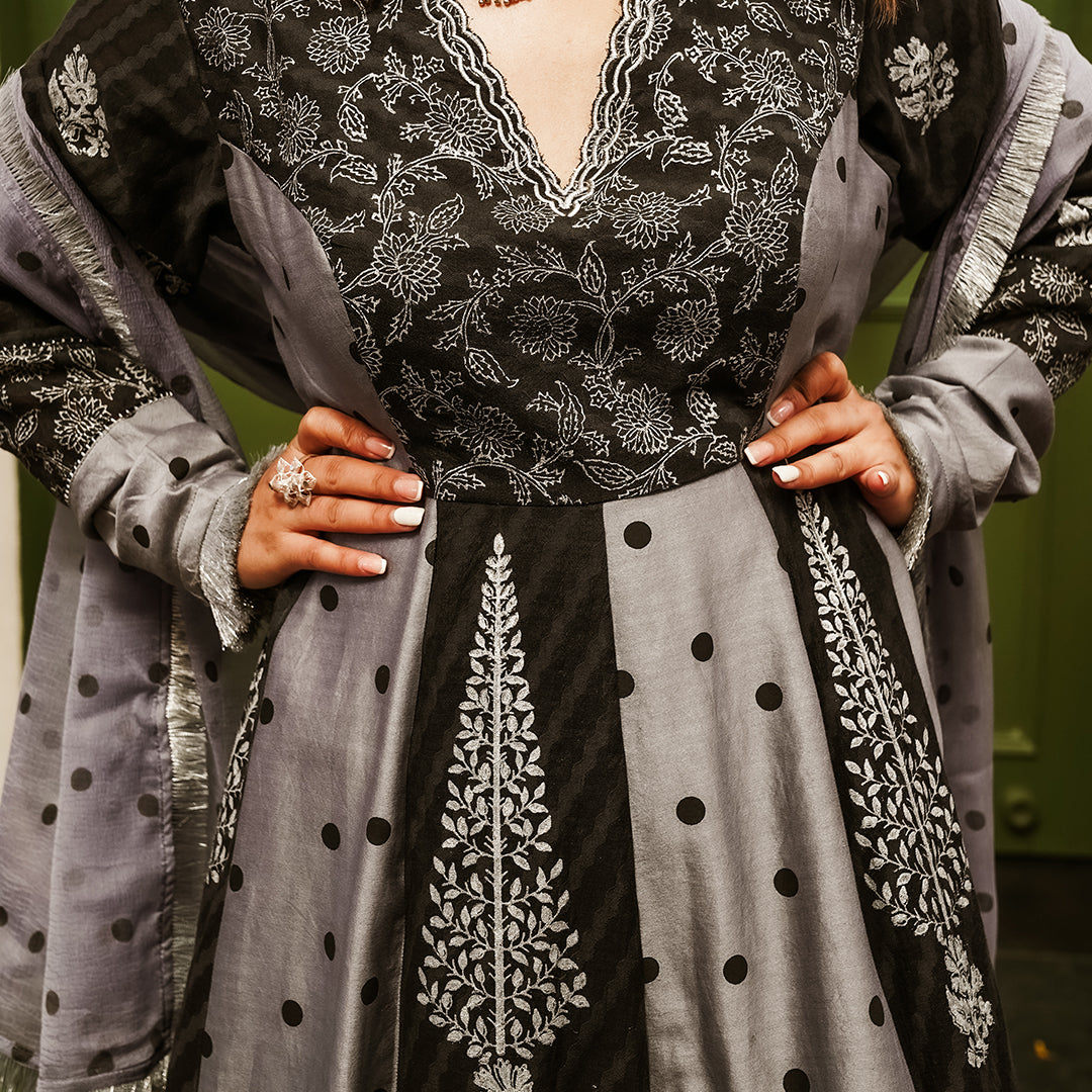 A women wearing black and grey Chanderi silk Anarkali kurta set.