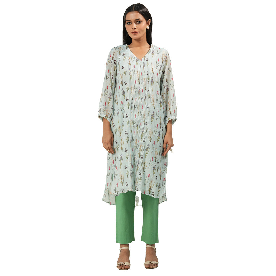 A woman wearing Green and White Colored Kurta Set with Pants.