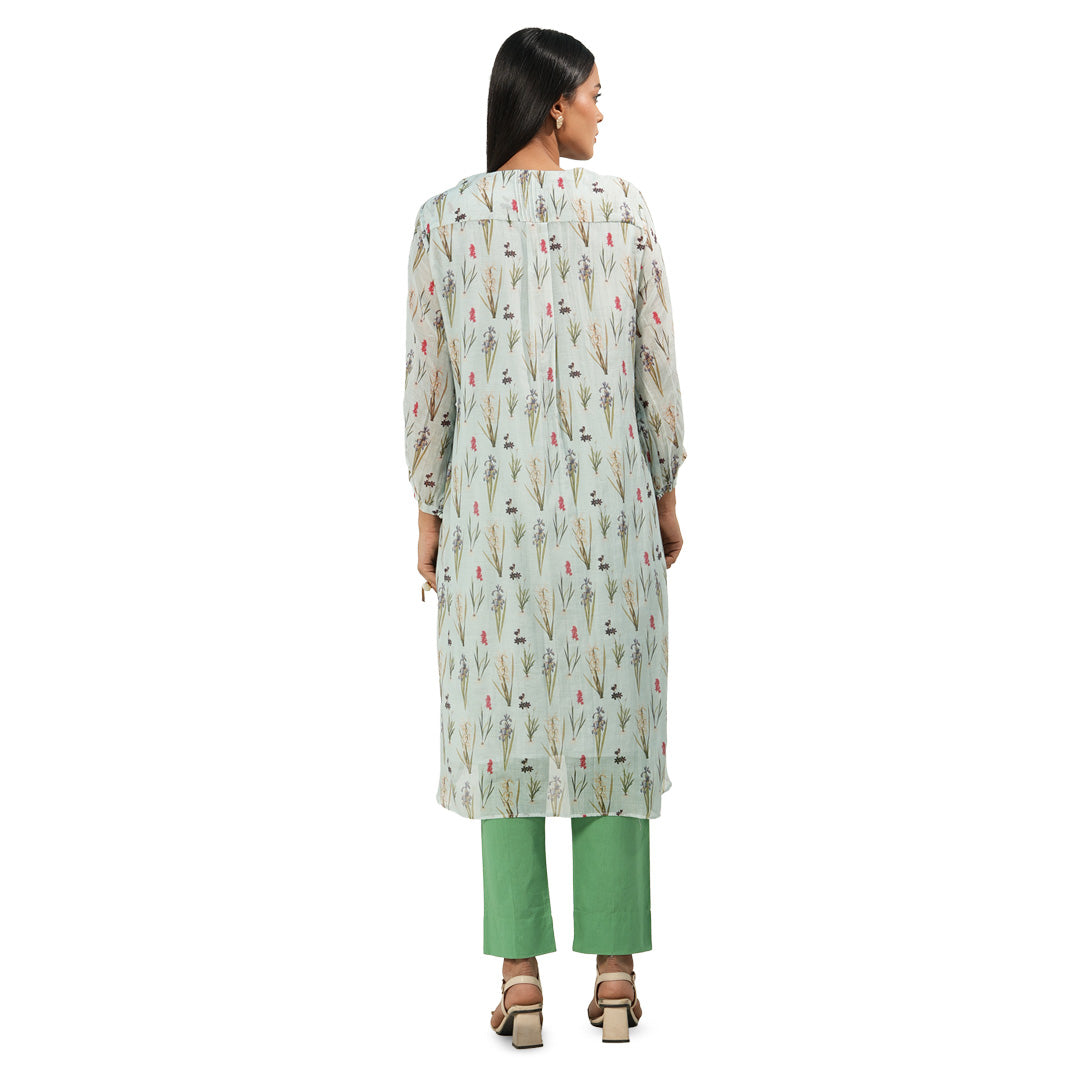 A woman wearing Green and White Colored Kurta Set with Pants.