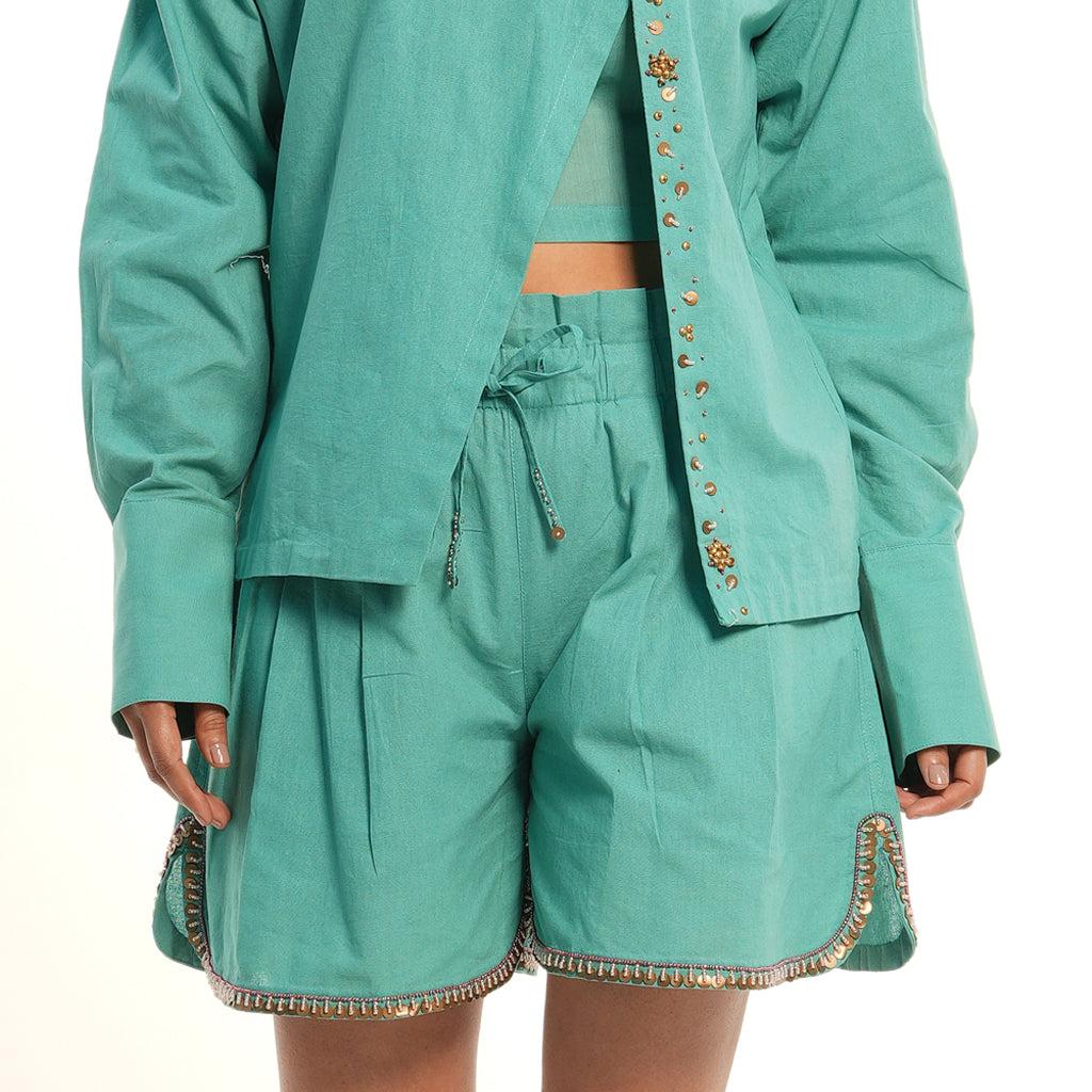 A women wearing sky blue colored co-ord set with short pants.