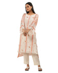 A women wearing Peach Colored Kurta Set with white pants.