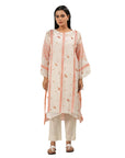 A women wearing Peach Colored Kurta Set with white pants.