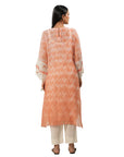 A women wearing Peach Colored Kurta Set with white pants.