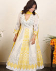 A women wearing white and yellow kurta set with Dupatta.