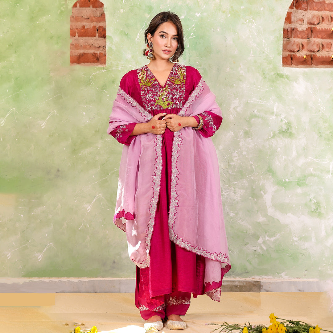 A woman wearing Pink Colored Silk Kurta Set with Organza Dupatta.